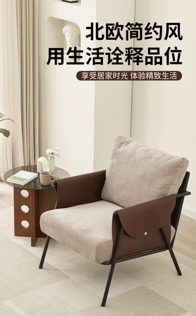 Lounge Chair With A Black Metal Frame, Light Grey Fabric Cushions, And Dark Brown Leather Armrests