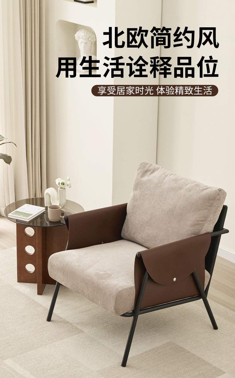 Lounge Chair With A Black Metal Frame, Light Grey Fabric Cushions, And Dark Brown Leather Armrests