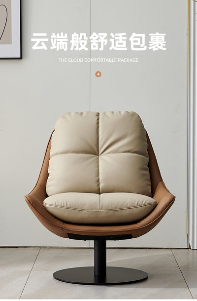Modern swivel lounge chair with a high-back and removable cushions, upholstered in off-white faux leather with a black metal base