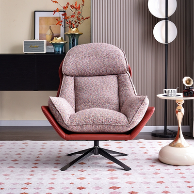 A Modern Fabric And Leather Accent Chair With a Swivel Base