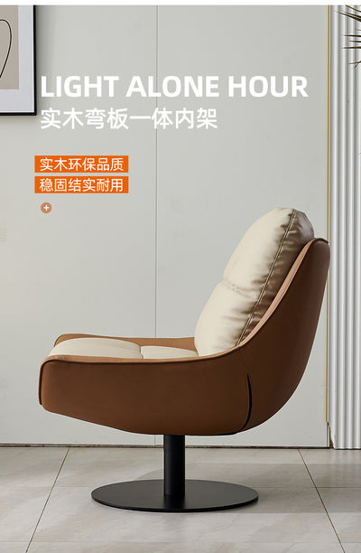 Modern swivel lounge chair with a high-back and removable cushions, upholstered in off-white faux leather with a black metal base