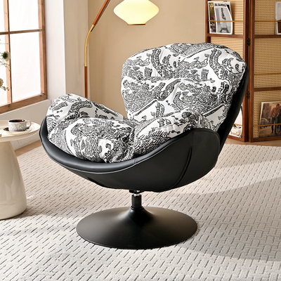 A Modern Swivel Accent Chair With a Brown Faux Leather Shell and a White And Black Patterned Fabric Cushion
