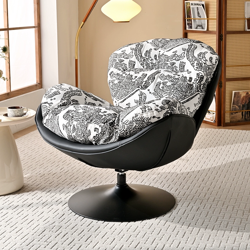 A Modern Swivel Accent Chair With a Brown Faux Leather Shell and a White And Black Patterned Fabric Cushion